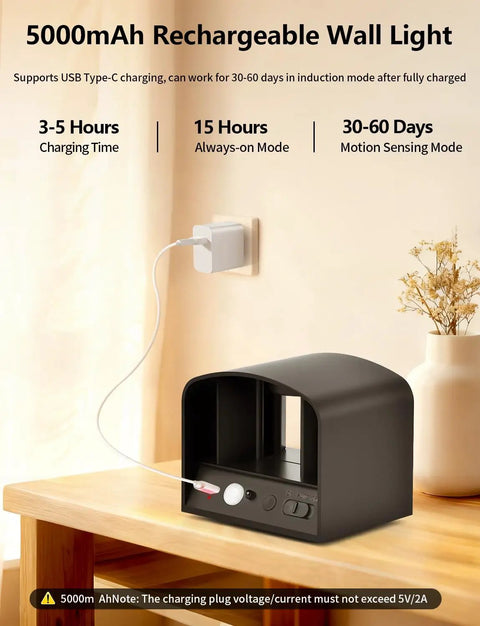 Go-To Remote Controlled Motion Sensor Wall Light charging on table with USB cable in black, 5000mAh battery visible