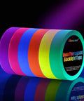Six Roll Pack UV Blacklight Reactive Gaffer Tape Set Featuring Six Neon Colors, 1 Inch Wide, 50 Feet Per Roll lined up on dark surface