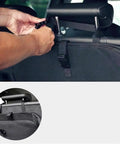 User attaching adjustable strap of EV cable tote to headrest for secure storage, showcasing heavy-duty design.