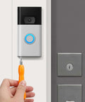 Replacement Copper Doorbell Screws Kit For Video Doorbell 2, 3 And Pro installed with screwdriver, securing device to wall.