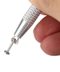 Close-up of Pro Grade All In One Piercing Taper And Ball Grabber Tool Set 14G Through 20G in hand, showing grip detail.