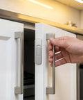 Get These Super Sleek 8Pcs Ultra Thin Magnetic Cabinet Door Catches For A No Drill Install that showcases a hand opening a white cabinet door.