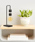 Unique Modern Levitating Lamp With Floating Light And Built In Qi Wireless Charger Sleek Dope Design on wooden shelf
