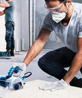 Worker using Ultra Thin Diamond Tile Blade 4.5 Inch 5 Pack for porcelain ceramic stone tile cutting on angle grinders with turbo mesh rim.
