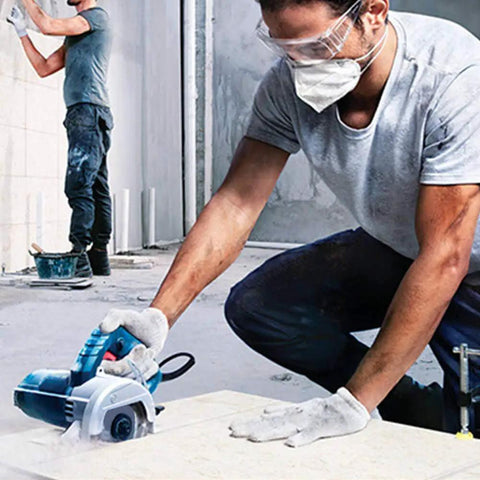 Worker using Ultra Thin Diamond Tile Blade 4.5 Inch 5 Pack for porcelain ceramic stone tile cutting on angle grinders with turbo mesh rim.