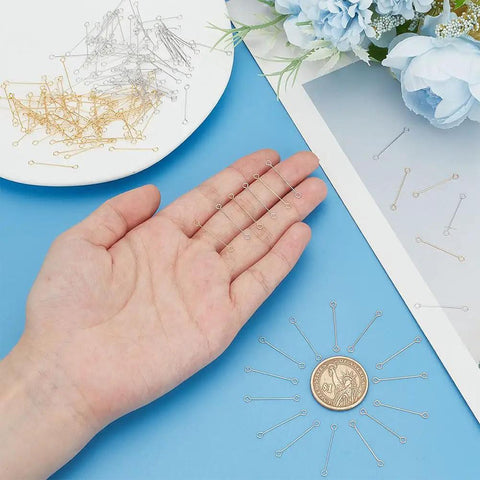 100 Pcs 25mm Brass Eye Pins Open Eye Pins 26 Gauge Double Sided Gold Silver Jewelry Findings For Diy Earrings Necklaces Bracelets Craft Making Durable Brass Construction For Beadwork And Jewelry Projects, shown on a hand