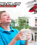 Child controlling Alloy RC Helicopter Aero Pilot Deluxe 3 Channel with Gyro and LED Lights outdoors, demonstrating realistic flight experience