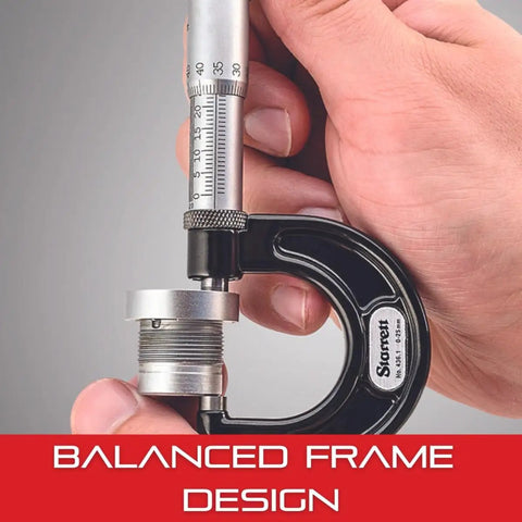 Close-up of outside micrometer with one-piece spindle, satin chrome finish, balanced frame design, held in hand, showing measurement.