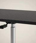 Close-up of the chrome adjustable pole and solid flat top on the Flexible Mobile Standing Desk With Smooth Rolling Wheels And No Sweat Height Adjustments.