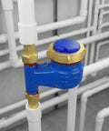 Vertical Water Meter With Three Quarters Inch NPT Couplings For Garden Or Home Use, mounted in plumbing system, iron body, brass fittings