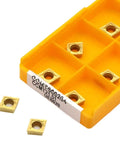 CCMT060204 carbide inserts in yellow container for CNC turning from Top Notch 10 Pc Indexable Carbide Lathe Tool Set For CNC Turning Includes CCMT060204 End Mill Blades Perfect For Steel And Stainless Job Shops.