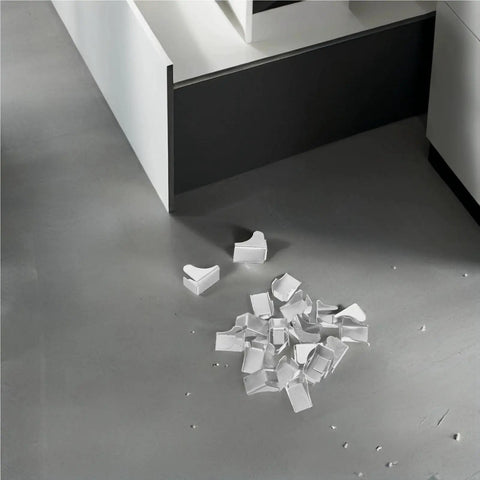 Built Tough Heavy Duty Shelf Clips And Bracket Set scattered on gray floor near cabinet