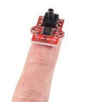Close-up of red DWEII air pressure sensor module board on fingertip, showing VCC OUT SCK GND pins