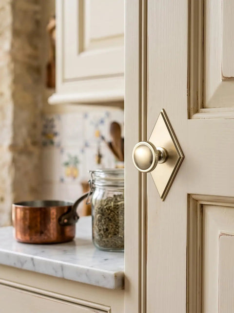 Slick Champagne Bronze Cabinet Knobs Pairing Fresh Rhombus Backplates With Fluted Dome Heads Brings Top Shelf Style To Your Kitchen Remodel Or Bathroom Refresh Alongside Three And A Half Inch Size Including A Set Of Six Go To Picks, displayed on a cabinet door.