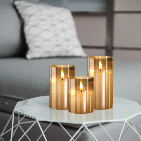 Glass Battery Operated LED Flameless Candles With Remote And Timer Pack Of 3 Real Wax Look Flickering Warm Light Gold on table