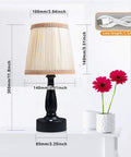 Lit Two Pack Battery Powered LED Night Lights Portable Dimmable Warm White Eye Protection Lamps With Remote set on a table