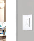 LED Dimmer Light Switch For Home Use 3 Way And Single Pole 600W Incandescent Max 150W Dimmable LED CFL Dimmable White Wall Plate Included Easy Slide Control Fits Modern Living Spaces Great For Dimming LED And Incandescent Lights In Any Room installed on a gray wall.