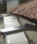 4 Pack Wedge Downspout Gutter Guard For 2 By 3 Standard Downspouts installed in gutter, showing debris removal and guard placement.