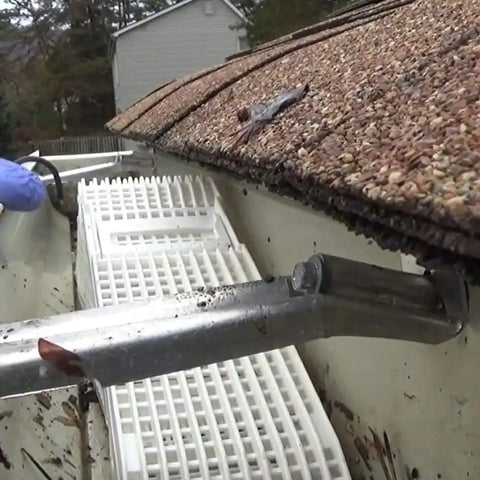 4 Pack Wedge Downspout Gutter Guard For 2 By 3 Standard Downspouts installed in gutter, showing debris removal and guard placement.
