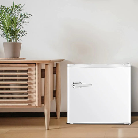 Mini Upright Freezer 1.2 Cu Ft Compact Build With Removable Slides And Adjustable Thermostat Dial In Bright White Finish next to a wooden table.