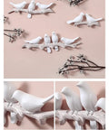 Chic Five Hook Wall Mounted Coat Rack With A Cool Blue Bird Vibe detailed view of white bird design on wall with tree branches.