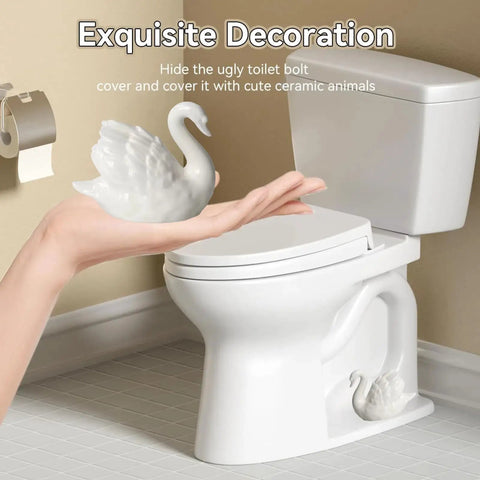 Upgrade Your Bathroom Game With Super Slick Ceramic Toilet Bolt Caps Featuring A Chic White Swan Design and Decorative Screw Covers That Totally Level Up Your Home Aesthetic And Keep Things Looking Fresh - Hand holding ceramic swan for toilet bolt cover.