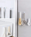 Heavy Duty Magnetic Hooks 30 Lbs Capacity 10 Pack Industrial Grade Rare Earth Magnets holding kitchen tools on refrigerator.