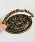 4-Pack Vintage Style Antique Brass Deer Pattern Bail Drawer Pulls, showcasing oval plate and zinc alloy construction.