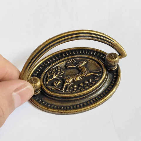 4-Pack Vintage Style Antique Brass Deer Pattern Bail Drawer Pulls, showcasing oval plate and zinc alloy construction.