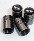 Genesis Black Chrome Wheel Valve Caps And Stem Covers For Cars Upgrade Your Ride With Slick Valve Caps Durable Leak Proof Tire Air Seals Easy Clip On Installation Street Ready Car Accessory, four caps displayed.