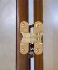 Hidden 180 Degree Zinc Alloy Cross Door Hinge for Cabinets and Furniture, Concealed Invisible Hinge Kit, installed on brown door frame