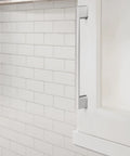 Installed Polished Chrome Cabinet Pull Cityscape Collection 7-3/8 Inch on white cabinet against subway tile backsplash