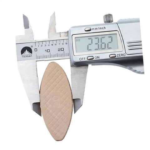 Caliper measuring biscuit from Beech Wood Biscuit Joiner Kit With 100 Pcs Biscuits For Woodworking, precise joint alignment