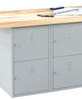 Rock Solid Heavy Gauge Steel Workshop Bench With Four Secured Padlock Lockers And A Thick Hardwood Top built for garage and man cave projects.