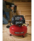 Workhorse Pancake Air Compressor With Six Gallon Oil Free Tank 150 PSI Max Pressure, red tank in use with nail gun.