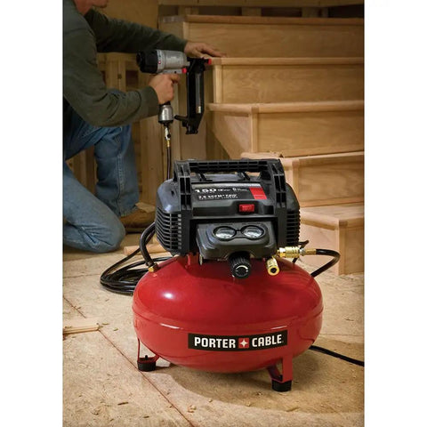 Workhorse Pancake Air Compressor With Six Gallon Oil Free Tank 150 PSI Max Pressure, red tank in use with nail gun.
