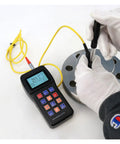 Top Shelf Digital Hardness Tester Portable Handheld Metal Gauge measuring steel hardness on a round metal plate with gloves.