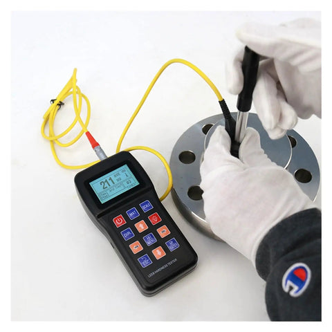 Top Shelf Digital Hardness Tester Portable Handheld Metal Gauge measuring steel hardness on a round metal plate with gloves.