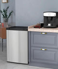 Compact Upright Mini Freezer With 3.0 Cubic Feet Capacity And Reversible Door For Dorm Life Apartments Rv Trips And Office Setups next to a coffee machine in a modern kitchen.