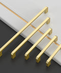 Brushed Gold Cabinet Pulls Set Of 10 5 Inch 128mm Brushed Brass Kitchen Cabinet Handles displayed in varying sizes on a black and white surface