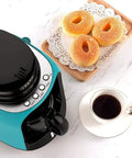 Hassle Free Mini Coffee Maker With Built In Bean Grinder And Glass Carafe, Solid Six Cup Drip Brewer next to donuts and coffee.