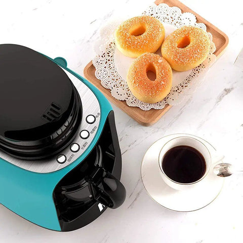 Hassle Free Mini Coffee Maker With Built In Bean Grinder And Glass Carafe, Solid Six Cup Drip Brewer next to donuts and coffee.