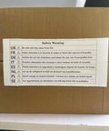 Safety warning label on a box with translations related to the Portable Pedal Generator For Off Grid Power And Emergencies 50 Watt And 100 Watt Manual Crank System Dual DC Output From One To Thirty Five Volts Emergency Backup Energy For Outdoor Adventures And Camping.