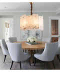 Slick Modern Marble Ceiling Pendant Light With Easy Dimmable Brightness And Genuine Stone Build That Totally Boosts Your Dining Room Or Kitchen Island Home Lighting Setup above a round wooden dining table with gray chairs.