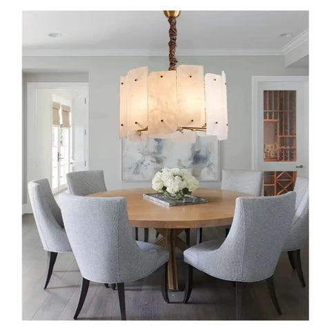 Slick Modern Marble Ceiling Pendant Light With Easy Dimmable Brightness And Genuine Stone Build That Totally Boosts Your Dining Room Or Kitchen Island Home Lighting Setup above a round wooden dining table with gray chairs.