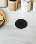 Espresso Machine Cleaning Disc 50mm Silicone Blind Filter Backflush Pad For Semi Automatic Coffee Makers shown on kitchen counter