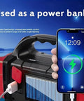 Solar Flashlight With USB C Rechargeable Power Bank in use charging a smartphone outdoors by a lake