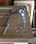 Rock Solid Stainless Steel Lag Screws And Bolts 20 Pack 3/8 Inch By 2-1/2 Inch Hex Head Fasteners in use with a socket wrench on wood.