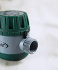 Close-up of mechanical water timer for lawn and garden with easy grip dial and manual bypass, no battery needed.
