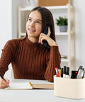 PU Leather Desk Organizer Caddy With Two Compartments Remote Control Holder Pencil Cup on a desk beside a person writing